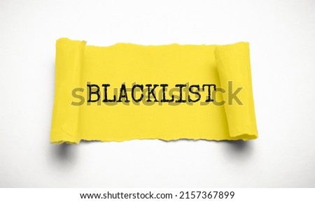 Word Blacklist on white background through hole in yellow paper, top view