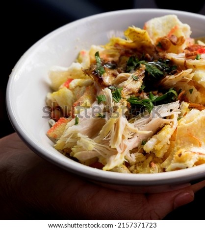 Bubur ayam or Indonesian rice porridge served with shredded chicken. 

 Royalty-Free Stock Photo #2157371723