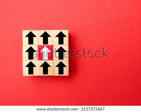 Wooden cubes with arrows in one direction. the concept