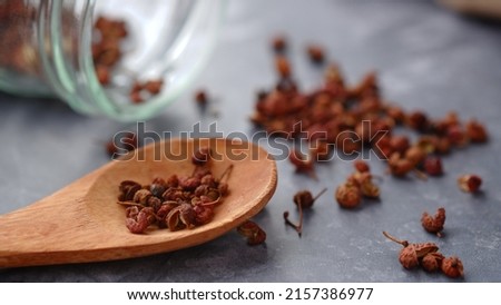 zechuan peppercorn on a wooden spoon. Chinese pepper is a spice commonly used in the Sichuan cuisine of China's southwestern Sichuan Province