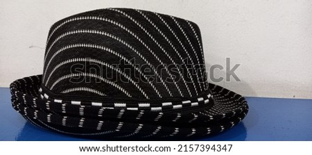 Black children's hat with white stripes