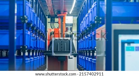 plastic boxes in the cells of the automated warehouse. Metal construction warehouse shelving Royalty-Free Stock Photo #2157402911