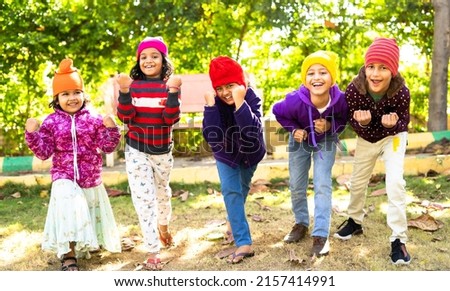 Cheerful Teenager girl kids in warmth winter wear shouting by looking at camera - concept of childhood happiness, positive emotion and outdoor activities