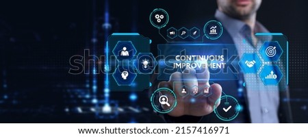 The concept of business, technology, the Internet and the network. A young entrepreneur working on a virtual screen of the future and sees the inscription: Continuous improvement Royalty-Free Stock Photo #2157416971