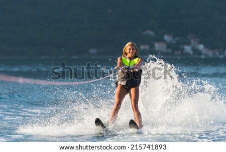 young woman water skiing on a sea