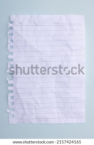 white paper with crumpled lines placed on a blue background. note paper Royalty-Free Stock Photo #2157424165