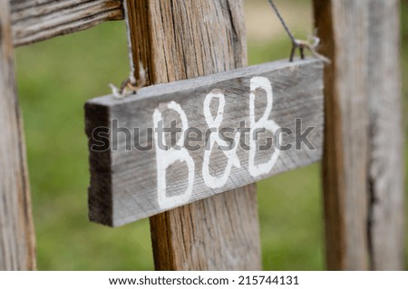 Closeup Of Old Signboard Bed & Breakfast Hanging On Fence