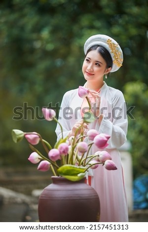 Ho Chi Minh city, Viet Nam: Vietnamese girl going to pagoda in ao dai Royalty-Free Stock Photo #2157451313