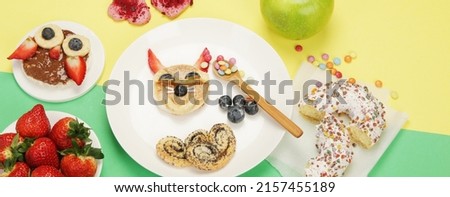Healthy toasts for kids on colourfull background. Healthy breakfast idea. Playful lunch. Top view, flat lay, copy space, panorama