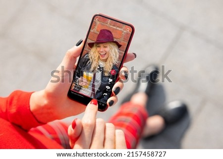 Woman viewing social media content on mobile phone Royalty-Free Stock Photo #2157458727