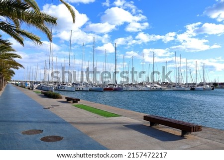 Yachts and Sailboat in the  La Marina de Valencia, Spain. Luxury yacht and fishing motorboat in yacht club at Mediterranean Sea. Skiff and motor boats in harbour. Yachting and sailing sport.