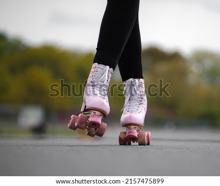 Horizontal picture of person rollerskating, close up of pink vintage quad roller skates. Concept: leisure activities. movement, summer, sports, vacations, free time, outdoor activities. 