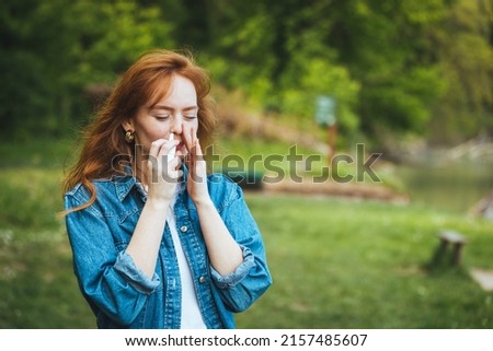 Woman is having flu and she is using nasal spray to help herself. Woman using nasal spray. Nasal spray to help a cold. Sick with a rhinitis woman dripping nose. Woman applies nasal spray Royalty-Free Stock Photo #2157485607