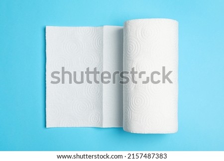 Roll of white paper towels on light blue background, top view Royalty-Free Stock Photo #2157487383