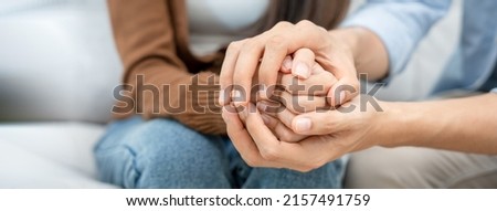 Couples hold hands to support each other while discussing family issues with a psychiatrist. Men and women have psychological empathy and understand after marriage. save divorce, Hand in hand together Royalty-Free Stock Photo #2157491759