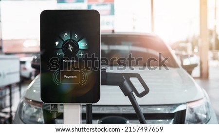 Ev electric vehicle charging station hub with visual icon screen display ui user self refueling interaction recharging, pump cable  eco energy environmental friendly transport industry automobile. Royalty-Free Stock Photo #2157497659