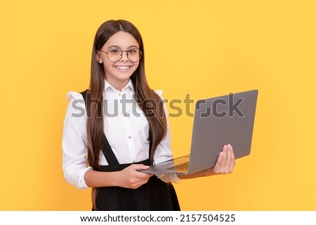 happy child in school uniform and glasses study on laptop, back to school Royalty-Free Stock Photo #2157504525