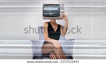 Amazing female with a television as a head trying to tune her TV. On the screen is glitch and distortion