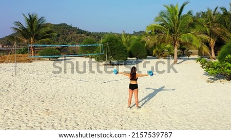 A female working out on the sand in Koh Samui, Thailand, Asia