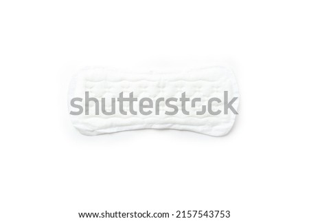 White cotton panty liner, sanitary pad on white background, top view, flat lay, minimalism. Menstrual cycle. Women's hygiene and health care.
