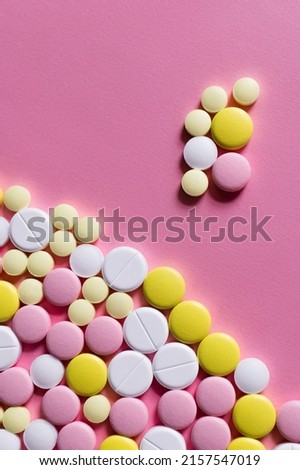 flat lay view of different round shape pills on pink background