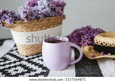 Purple cup with tea on a lilac background. beautiful good morning.