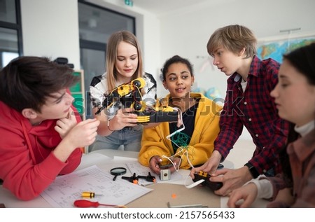 Group of students building and programming electric toys and robots at robotics classroom Royalty-Free Stock Photo #2157565433