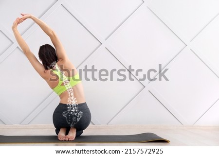 Young woman training in gym. Concept of healthy spine Royalty-Free Stock Photo #2157572925