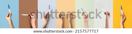 Set of many female hands with pregnancy tests on colorful background Royalty-Free Stock Photo #2157577717