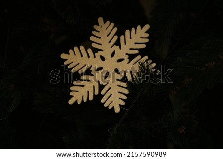 A shot of a fake snowflake on a Christmas tree