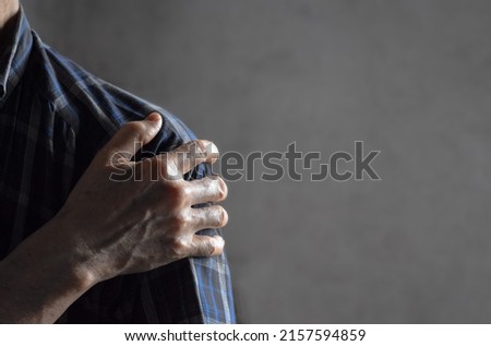 Pain in the shoulder joint of Southeast Asian elder man. Concept of frozen shoulder. Royalty-Free Stock Photo #2157594859