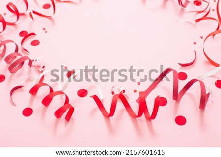 birthday background with red serpentine on pink