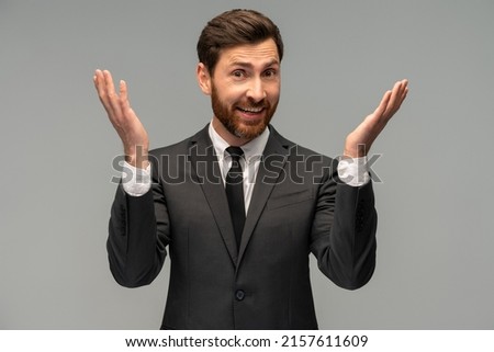 Waist up portrait view of the modern business man in formal suit raised arms and laughing isolated on grey background 