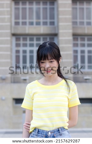 Portrait of thai china adult beautiful girl yellow shirt blue jeans relax time