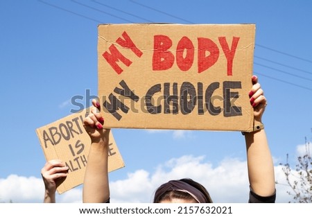 Protesters holding signs My Body My Choice and Abortion Is Healthcare. People with placards supporting abortion rights at protest rally demonstration. Royalty-Free Stock Photo #2157632021