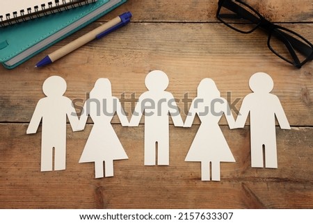 Group of people, symbol of community, teamwork, and cooperation over wooden table