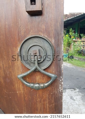ancient door handle on old wooden door