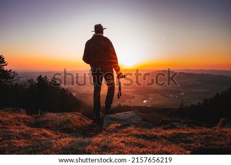 A photographer takes photos in nature at the sunset  Travel Lifestyle Hobby Concept Adventure Active Outdoors