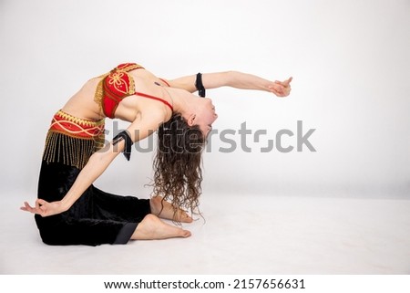 A Caucasian female dancer of Arabic dance in a studio
