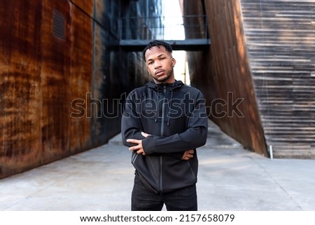 Handsome young African American man with dreadlocks in an urban setting Royalty-Free Stock Photo #2157658079