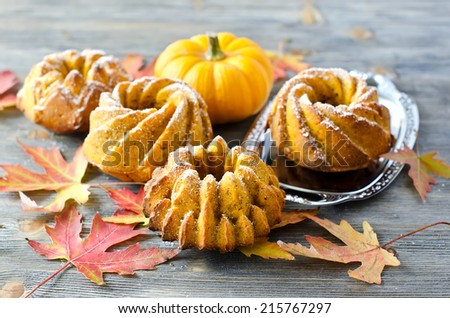 Cakes with pumpkin and autumn leaves selective focus