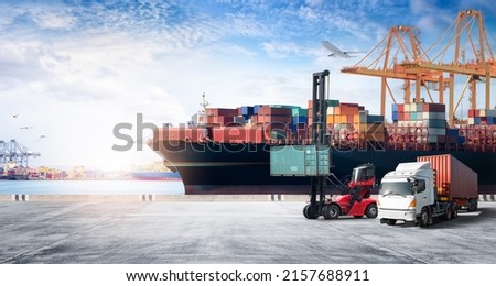 Container cargo freight ship during discharging at industrial port move to container yard by trucks, handlers, cargo plane, copy space, logistic import export background and transport industry concept Royalty-Free Stock Photo #2157688911