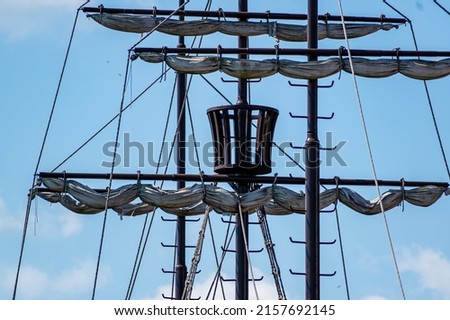 Masts with a guard basket against the blue sky. Illustrative photo Royalty-Free Stock Photo #2157692145