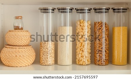 organization of food storage in the kitchen, transparent reusable jars for cereals and pasta, zero waste pantry Royalty-Free Stock Photo #2157695597