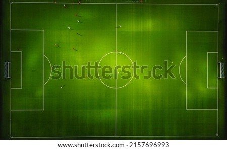 Aerial top view from flying drone of the football field in the evening. Royalty-Free Stock Photo #2157696993