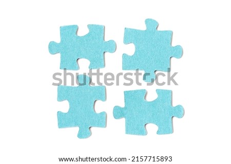 Four pieces of a blue color puzzle isolated on a white background. Teamwork concept