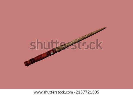 wooden magic wand on pink background