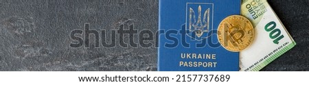 Hundred euro banknote inside Ukrainian passport. 