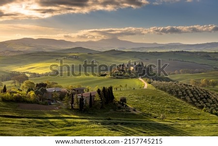 Tuscan countryside near San Quirico d'Orcia on foggy early morning sunrise in Tuscany, Italy, April. Royalty-Free Stock Photo #2157745215