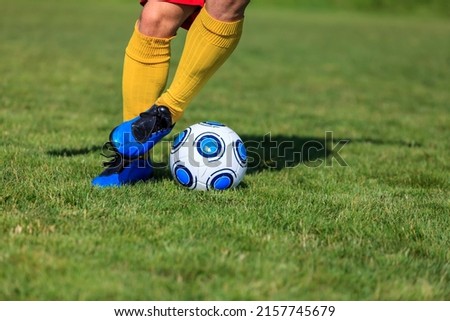 Close-up image of the feet of a footbal player dribbling Royalty-Free Stock Photo #2157745679